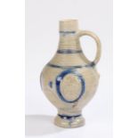 17th Century salt glazed jug, with ring decoration to the top and three medallions depicting two