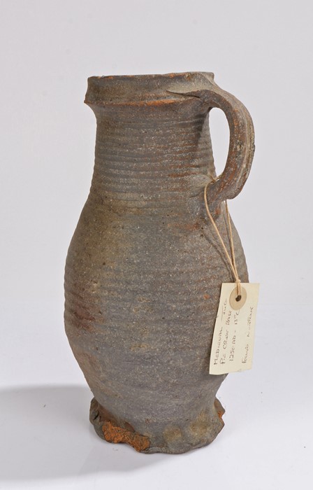 Medieval pottery jug, circa 1250 - 1300 A.D. with ring decoration and a loop handle, with a tag