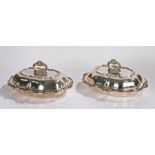 Pair of silver plated entrée dishes, the acanthus leaf scroll handle above the shaped lid and