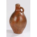 18th Century stoneware bottle, in the form of a Bellarmine, the rounded neck above a baluster