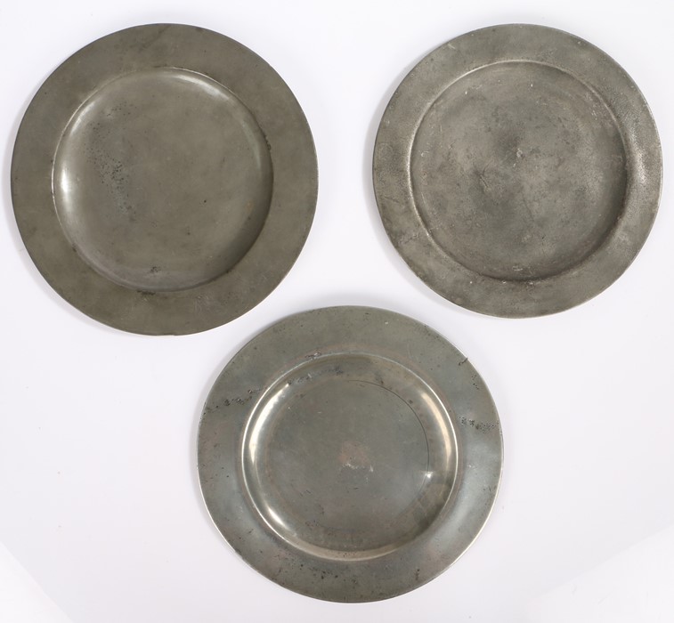 Three 18th/19th Century pewter plates, F MM to the underside of one with rubbed touch marks, the