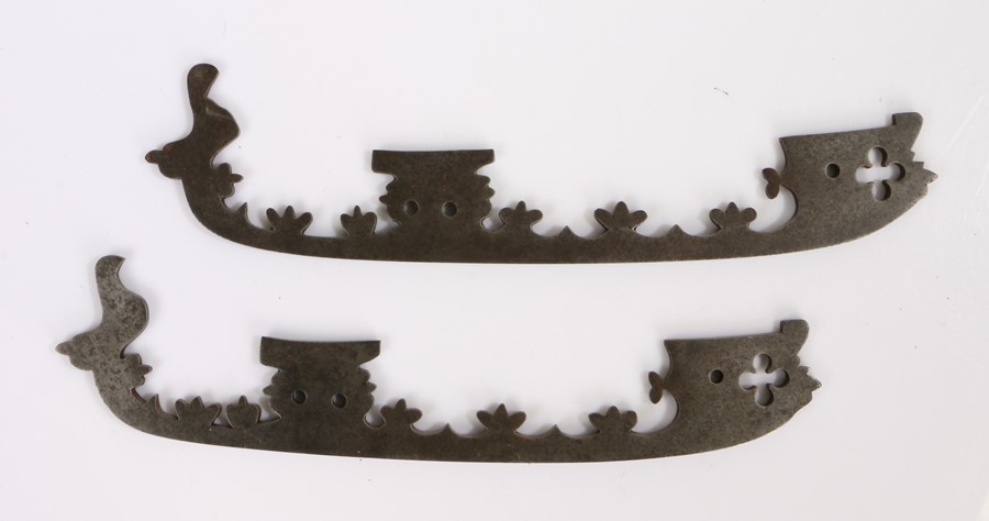 Pair of 19th Century steel ice skates, with arched bases and stylised flower design decoration, 30cm