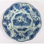 18th Century Delft dish, with a central Oriental scene and gadrooned lips with conforming scenes,