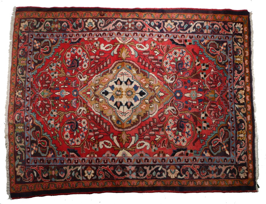 Persian Feragham carpet ,the central medallion with flowers within a red foliate surround and four