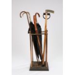 Victorian stick stand, containing a horn handled silver collared stick, two umbrellas, a dipper