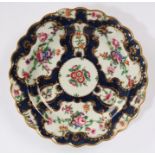 Worcester porcelain scale pattern plate, circa 1775, painted with flora within gilded cartouches