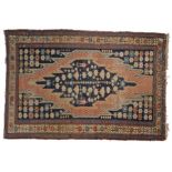 Persian Maslagian Dozar rug with a central blue panel having two figures and flowers, further flower