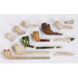 Collection of 17th to 19th Century pipes and pipe fragments, with military examples, a green glaze