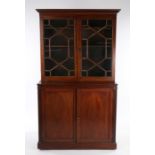 19th Century mahogany bookcase cabinet, the concave cornice above a Greek key frieze and a pair of