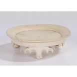 18th Century creamware pottery stand, the circular dish top above bat style supports, 13cm wide