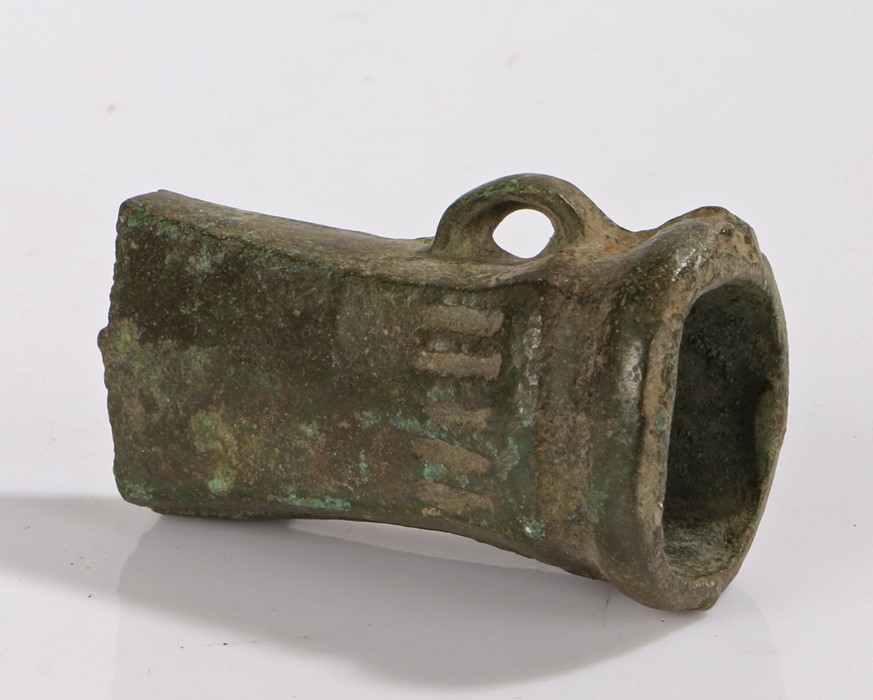 British Bronze age axe head, 1000 B.C. with a loop to base and four lines decorated to the rear of