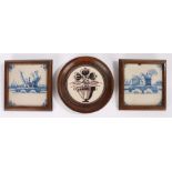 Three 18th Century Delft tiles, to include two with buildings by a lake and the third circular