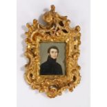 Late 18th Century portrait miniature, of a gentleman in a black jacket, housed within a Rococo
