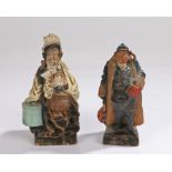 Amusing pair of late 19th Century spill vases, as a portly gentleman with a book and bag, the lady