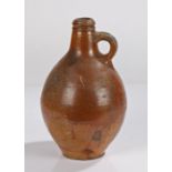 Early 18th Century salt glaze pottery jug, in brown with a short neck and handle above the bulbous