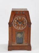 Arts and Crafts mantle clock, the dark stained case with tapering top section above reeded pilasters