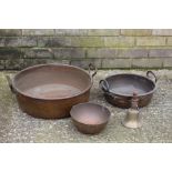 Two copper preserving pans, copper bowl, brass hand bell with turned wooden handle (4)