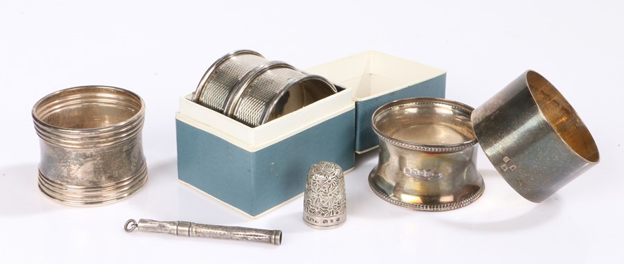 Silver, various dates and makers, to include five napkin rings, sliding cigar piercer, thimble, 2.