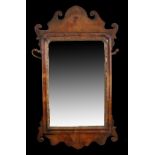 George II style walnut wall mirror, with scrolled and shaped frame, rectangular plate glass mirror