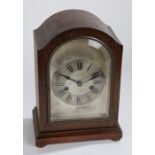 Early 20th Century oak cased mantel clock, having a glazed door enclosing a silvered dial with roman