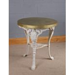 Cast iron table, the later gilded metal top above a base with figural legs united by an under tier