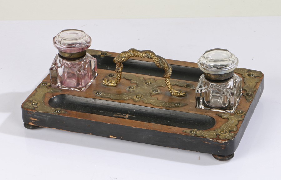 Victorian walnut desk stand, having twin glass inkwells either side of a gilt ormolu carrying handle