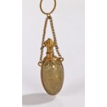 Egyptian Revival gilt metal scent bottle, of ovoid form, having lift up top attached with a chain,