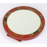 Chinese chinoiserie easel mirror, or circular form, decorated with figures and buildings on a red
