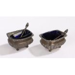 Pair of late Victorian silver salt cellars, Chester 1897, each with blue glass liners, gadrooned