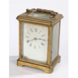 French brass cased carriage clock, the white enamel dial with Roman numerals, 14cm to top of handle