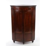 George III mahogany and boxwood strung standing corner cabinet, the bow front with a pair of doors