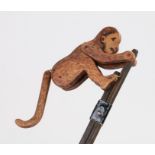 Carved wooden and painted toy in the form of a climbing monkey, 37cm long