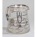 20th Century white metal overlaid glass jug, with silvered handle, the cylindrical body overlaid
