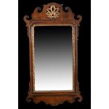 George III style mahogany frame wall mirror, with scroll borders and pierced gilt motif above a