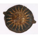 Tin Sun plaque, in gilt on a black ground, 17cm diameter