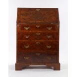 18th Century style walnut bureau, of narrow proportions, the sloping fall with feather crossbanded