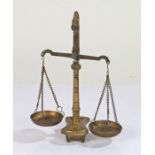 Small set of brass scales, raised on a shaped base and four feet, 19cm high