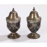 Pair of Edwardian silver pepperettes, London 1906, maker J.C.L, each with lift up lids enclosing
