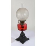 Best British Make oil lamp, the frosted foliate etched globe above a ruby glass reservoir and