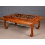 Chinese pine coffee table, of low rectangular form, having pierced geometric design top and raised