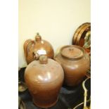 Stoneware, to include two brown glaze jugs and a lidded pot, the jug 32cm high, (3)
