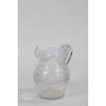 19th Century cut glass jug, the shaped lip and spout above a hatched glass body, 14.5cm high