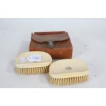 Pair of 1920's/30's ivory brushes, with Art Deco monograms to each, housed within a leather case (