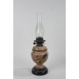 Victorian pottery oil lamp, the glass chimney above the pottery base with leaf and flower