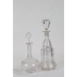 Two 19th Century glass decanters, the first tall example with a shaped ribbed body, 33cm high, the