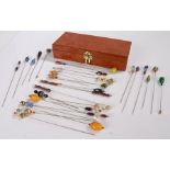 A collection of hat pins housed in a wooden box.