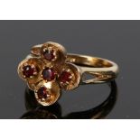 9 carat gold garnet set ring, with five garnets to the folate stylised head, ring size N