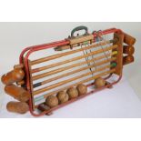 Croquet set, housed in a red painted metal frame