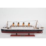 Model depicting RMS Titanic, on a red plinth base with name plate, 54cm long, 19cm high