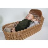 Wicker dolls cribs with an early 20th century doll and a plastic doll (3)